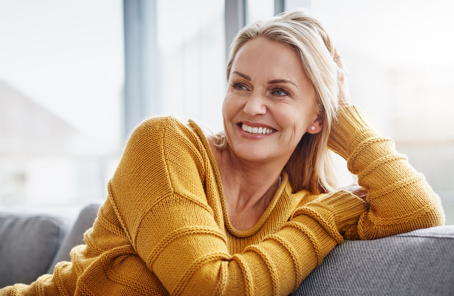 medical spa patient model in a mustard-colored sweater