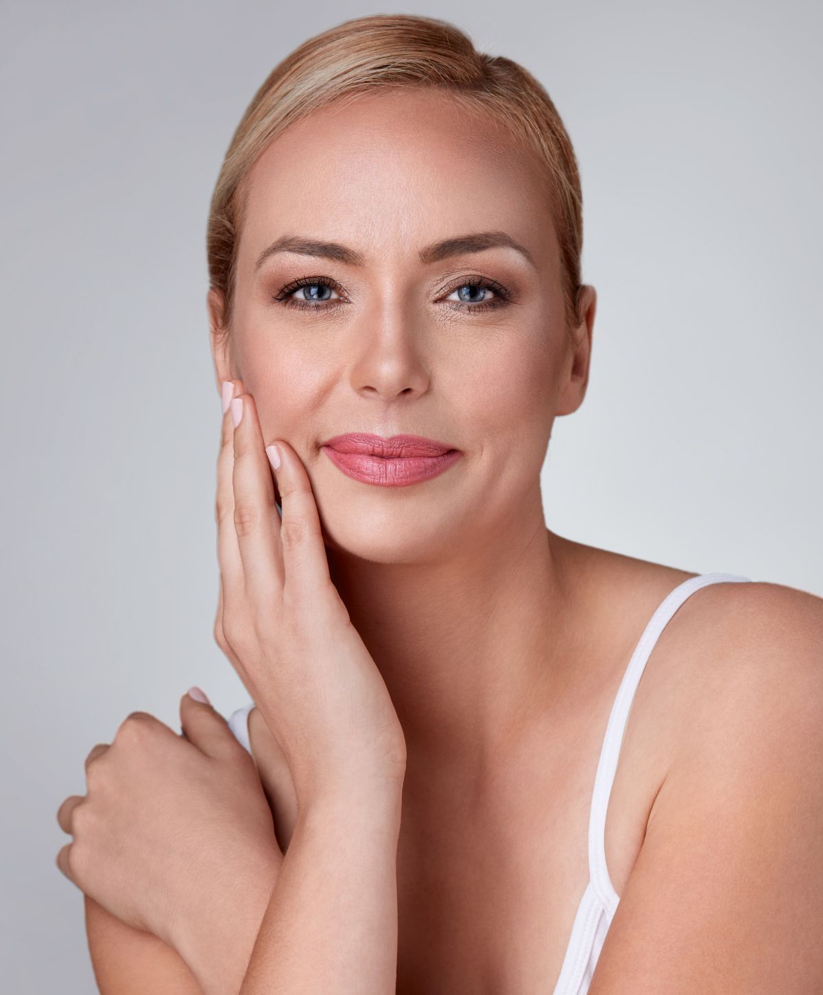 vi peel patient model touching her face and smiling