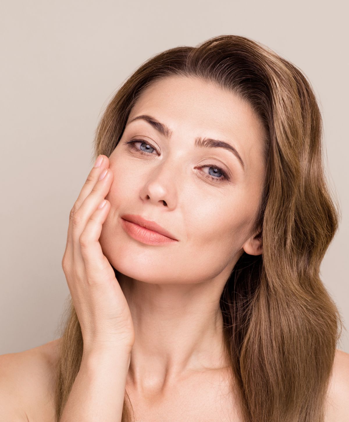 co2 laser resurfacing patient model touching her cheek and smiling softly