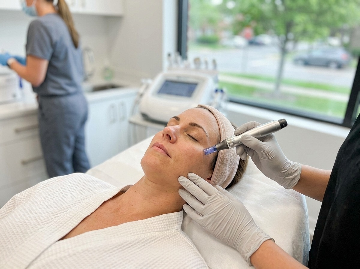 Woman receiving skin treatment in clinic setting.